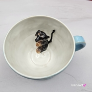 Filiżanka ceramiczna jamnik błękitna z czarnym jamniczkiem uroczym ręcznie toczona i malowana filiżanka ze spodkiem przenikające się szkliwa 300 ml z jamnikiem kubek